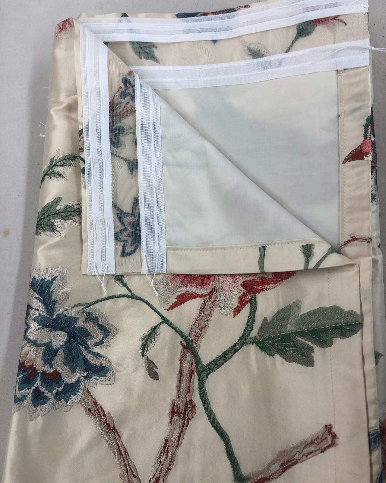 Lined silk drape, edge turned back to show the white lining