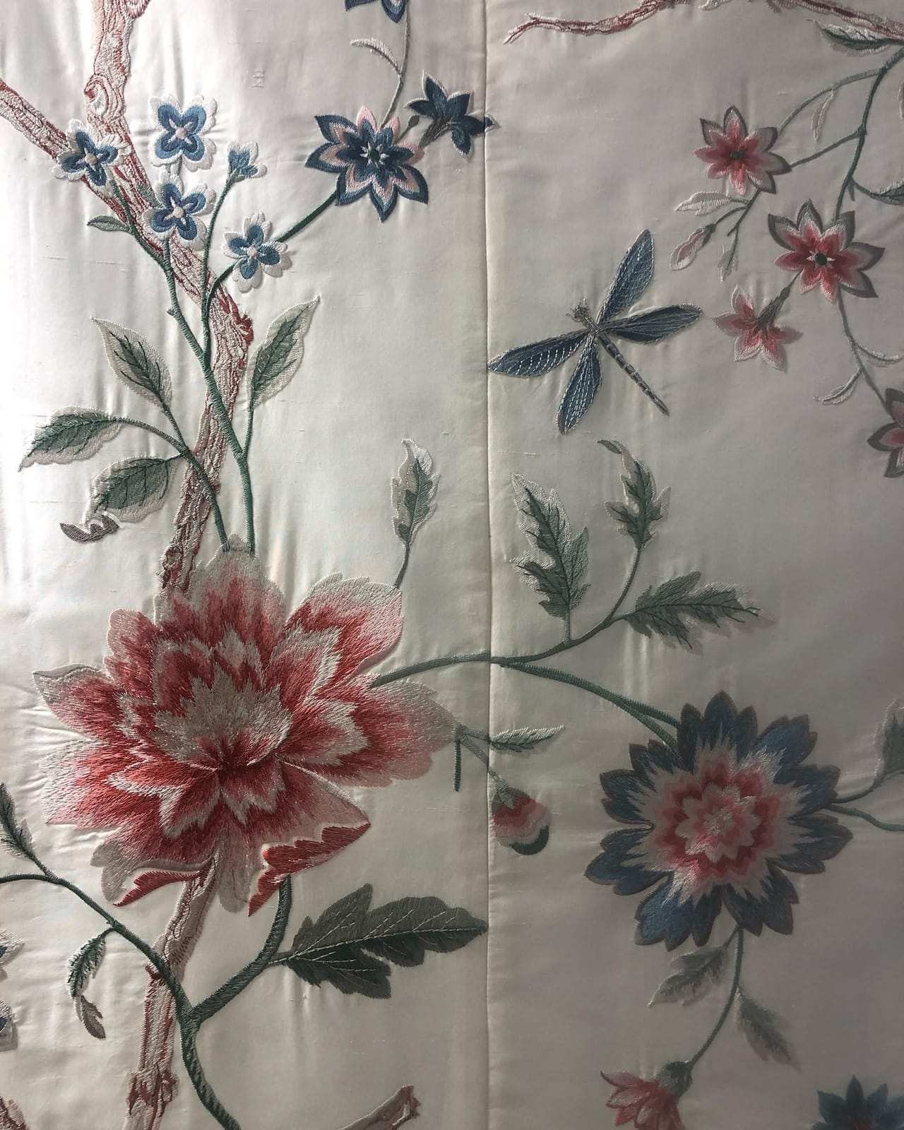 Seam between two silk widths with the embroidered pattern matched across it
